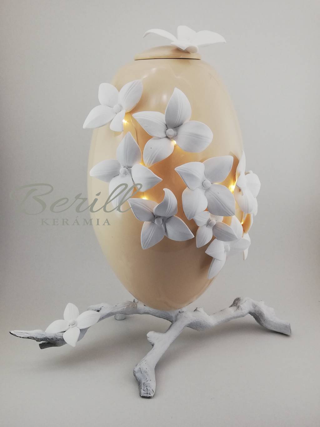 Kerámia ovál urna drapp fehér virágokkal, lábon álló,led hangulatvilágítással.  OU-DFVL